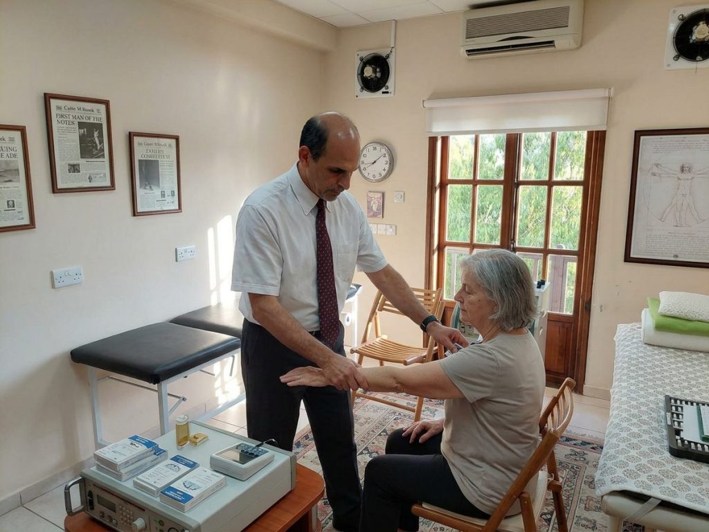 Dr. George Georgiou testing a patient’s arm muscle response