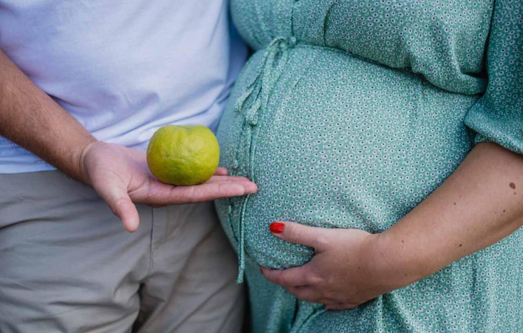 A pregnant mother holding a lime