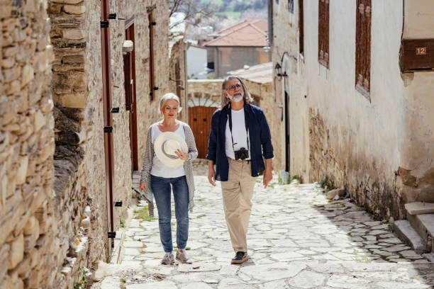 Visitors walking up a stone street in a Cyprus village