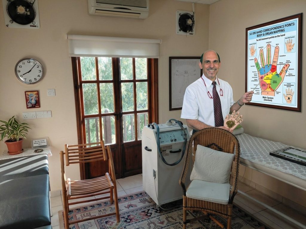 Dr. George pointing to a chart of the hand’s correspondence points
