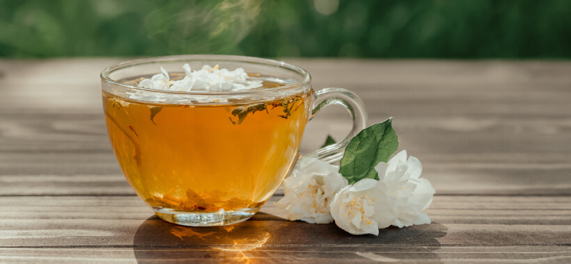 A cup of herbal tea with flowers