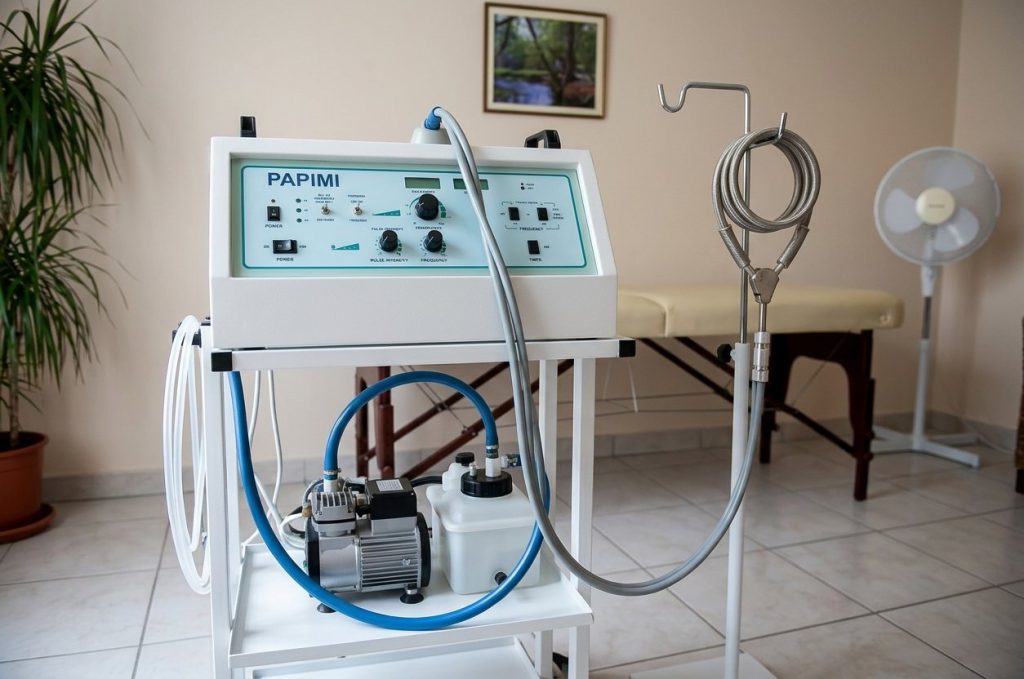 The PAPIMI device on its trolley beside a treatment couch